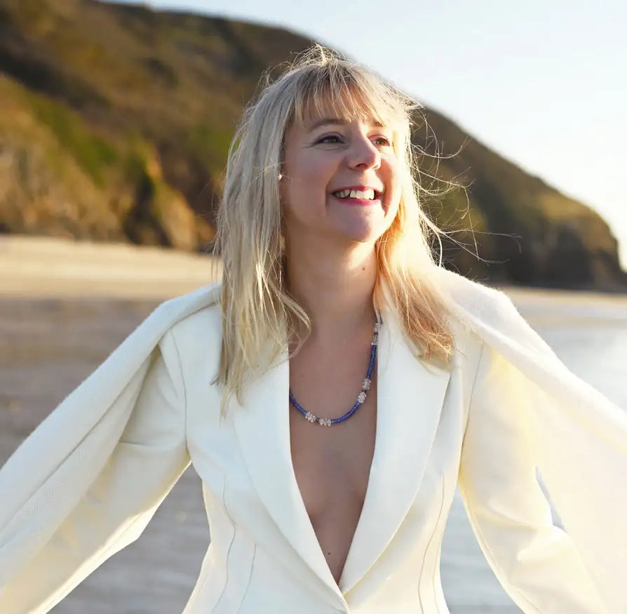 Une femme portant un blazer blanc à manches longues et à encolure en V profond.